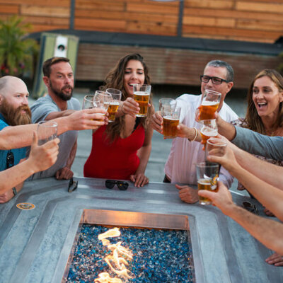 Friends cheering with beer cups at Tap It Brewing Company